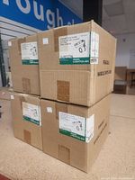 Four cardboard boxes stacked containing Philips Lightolier Lytespan track lighting fixtures, each labeled with model LLA0127AL, marked fragile.