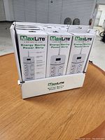 Lot of 12 brand new MaxLite Energy Saving Power Strips in retail packaging displayed in a box