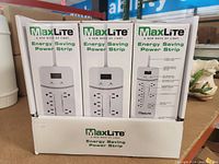 Box showing 3 MaxLite Energy Saving Power Strips in original packaging