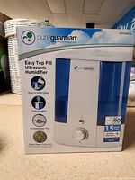 Box front showing Pure Guardian ultrasonic humidifier 1.5 gallon, easy top fill, aromatherapy tray, and silver clean protection.