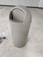 Front exterior photo showing entire gray dome-top trashcan on floor.