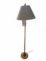 Floor lamp with off white antiqued finish standing upright, conical fabric shade, rounded base, and slim pole.