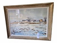 Framed watercolour painting depicting a snowy farm landscape with buildings, trees, and a church steeple.