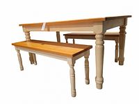 Side angle view of the rectory table with one bench in the foreground showing the solid wood tabletop and turned legs.