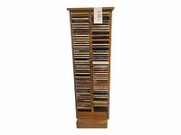 Full view of the wooden tapered rotating CD stand loaded with CDs
