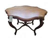 View of table top showing scratches and scalloped edges.