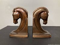 Front view of both bookends showing stylized horse head profiles