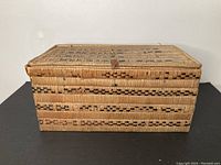 Front view of closed basket showing woven exterior pattern and overall form