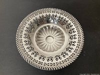 Top-down view showing pierced floral pattern and sunburst center