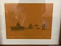 Full view of the framed wall art print showing the sled and figures scene on brown background.