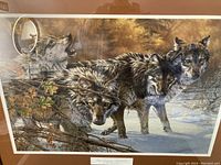 Framed art print showing a detailed scene of four timberwolves in a natural snowy and wooded environment.