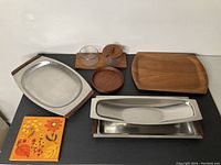 Overview of the 7 vintage Danish pieces including trays, bowls, glass container, and decorative ceramic tile.
