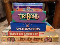 Stack of five board games including 13 Dead End Drive, Battleship, Wordsters, TriBond, Whoonu