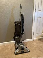 Full view of the vacuum cleaner standing upright showing metal body and cloth bag with Royal Pro Series logo.