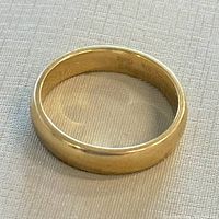 Top view of the 10K yellow gold ring showing the smooth, polished surface and gold color.