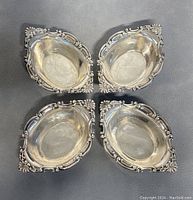 Overhead view of all four bowls showing shape and decorative border