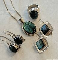 Lot of 925 silver jewelry including necklace, ring, and two pairs of earrings with green labradorite stones.