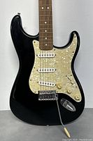 Front of guitar body showing pickguard and pickups