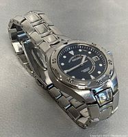 Seiko Kinetic 100M wristwatch angled to show watch face, stainless steel bracelet, and clasp.