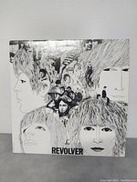 Front cover of The Beatles Revolver LP with iconic illustrated faces collage, shows minor wear.