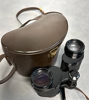 Binoculars positioning with case, showcasing overall condition and accessories included.