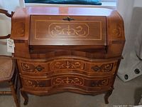 Front view, drop-front closed showing marquetry panels and brass hardware