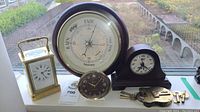 Group shot showing barometer, carriage clock, Baby Ben, desk clock/hygrometer, and winding keys on window sill
