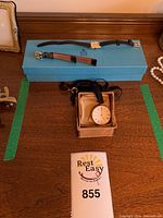 Birks blue presentation box displaying the wristwatch with straps and the pocket watch in its small box