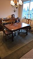Solid wood rectangular dining table on rug with six chairs in room