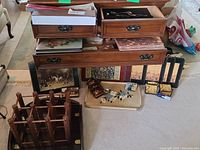 Overview of wooden storage furniture with drawers, decorative trays, placemats, and coasters on the floor