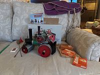 Overview of steam roller model on sofa with box, manual, tools, fuel tablets