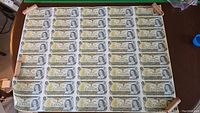 Full view of the uncut sheet showing 35 one-dollar notes in 5 rows of 7