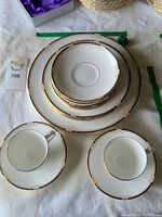 Top view showing stacks of dinner plates, salad plates, saucers and two teacups on saucers