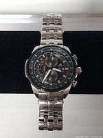 Front view of Casio Edifice watch showing black dial with chronograph subdials and tachymeter bezel.