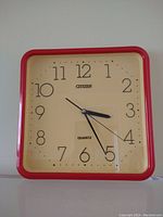 Front view of the vintage Citizen wall clock showing clean clock face with black numbers and black hands enclosed in red frame with glass cover.