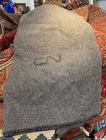 Grey wool blanket folded showing the CN Rail logo on top.