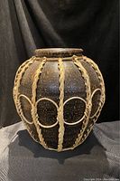 Front angled view of the Hudson's Bay vase showing the braided trim and textured ceramic surface.