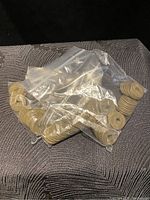 Coins in plastic bags showing circular coins with square holes and engraved characters.