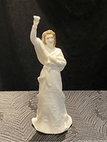 Front view of Royal Doulton "Au Revoir" porcelain figurine showing raised right arm, detailed face and clothing textures.
