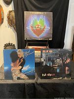 Front view of three vinyl records displayed, showing Joe Cocker, Rod Stewart, and REO Speedwagon album covers.
