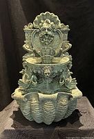 Full view of the tabletop water feature showing multi-tiered basins and ornamental face detail.