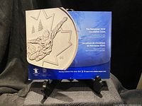 Front view of Vancouver 2010 circulation coins presentation folder with embossed hockey player design and maple leaf motif.