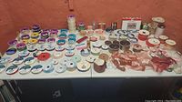 Large assortment of ribbon spools arranged on a table showing various colors and types.