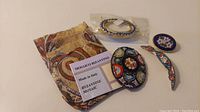 Lot of Italian mosaic jewelry including brooches and bracelet with paper label and decorative pouch