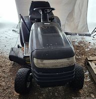 Front view showing black hood, integrated headlights, paint chips on hood and grill