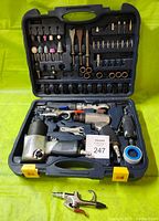 Photo showing the Mastercraft air tool set in black hard plastic case with six main air tools including air impact wrench, air hammer, die grinder, ratchet wrench, two air blowers, and numerous accessory bits and supplies organized in molded compartments.