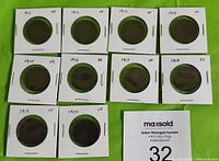 Photo of ten Canada Large Cents from 1911 to 1920, with graded conditions ranging from VG to EF, each in protective coin holders on a green background.