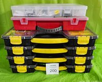 Stack of six cases including four black plastic cases with yellow handles, one red case, and one transparent case with compartments, all closed