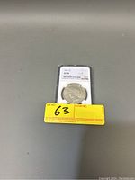 1925 US 1 oz Silver Peace Dollar displayed in NGC holder with AU 58 grade visible, front view.