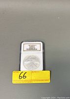 Obverse of 2003 US Silver Eagle coin graded MS 69 in protective slab with label.